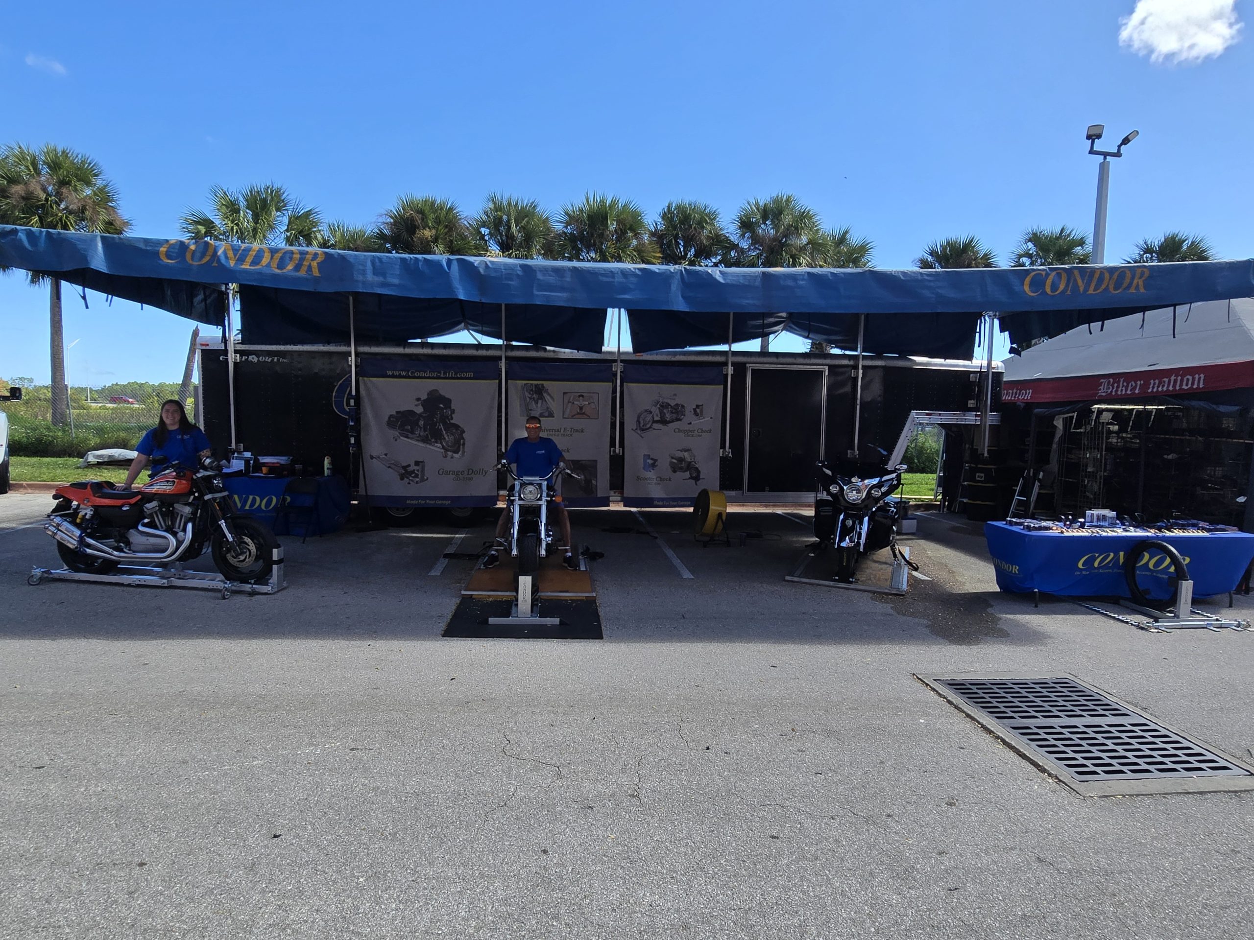 Motorcycle exhibition booth with bikes and banners.